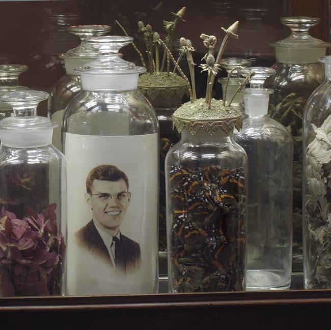Echoes_cabinet detail glass jars photo of man