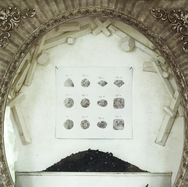 Shadowboxes_silver oval frame black minerals and arched geometric wreath
